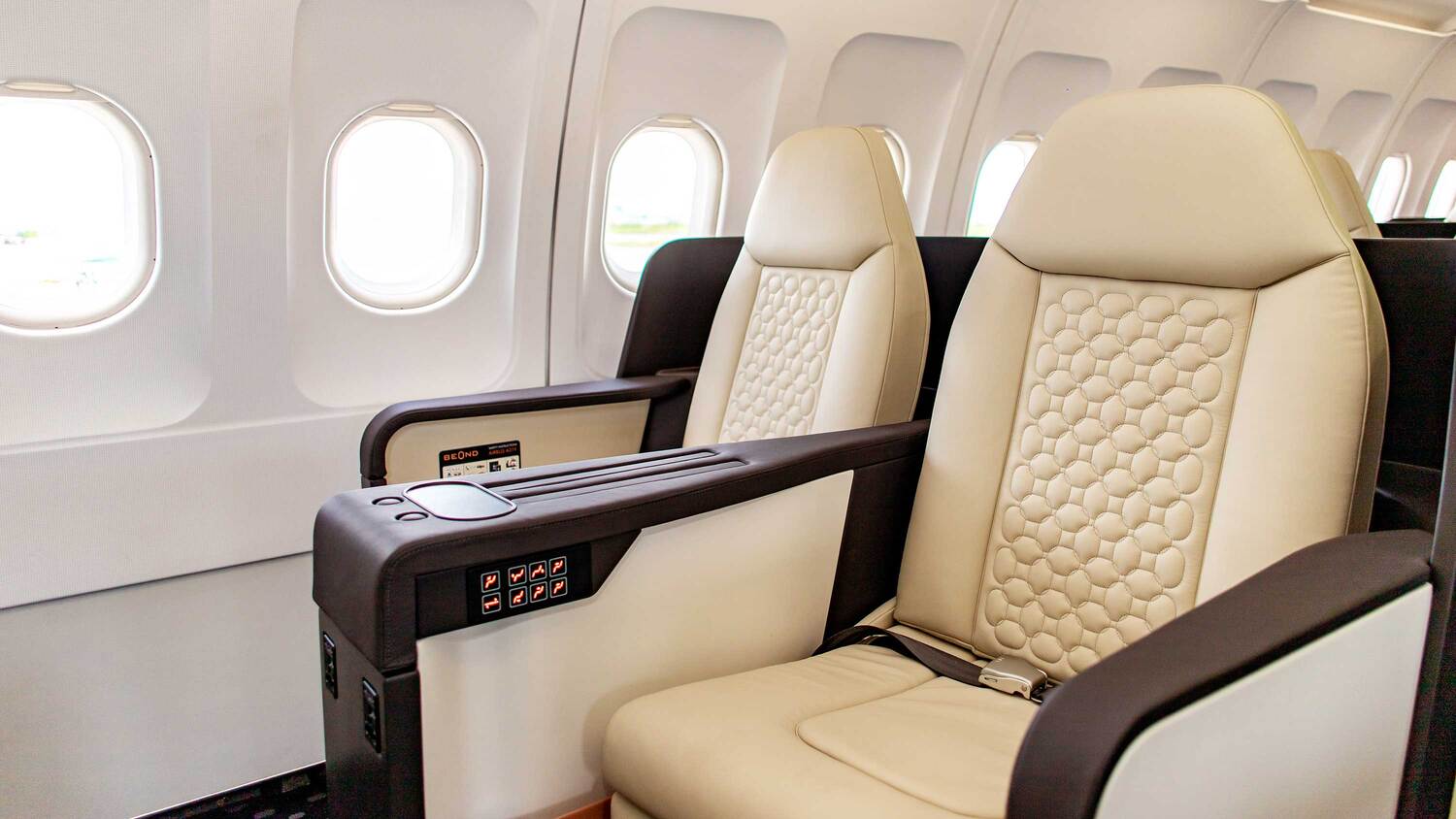 Close-up of a beOnd Airlines cream leather seat with diamond stitching
