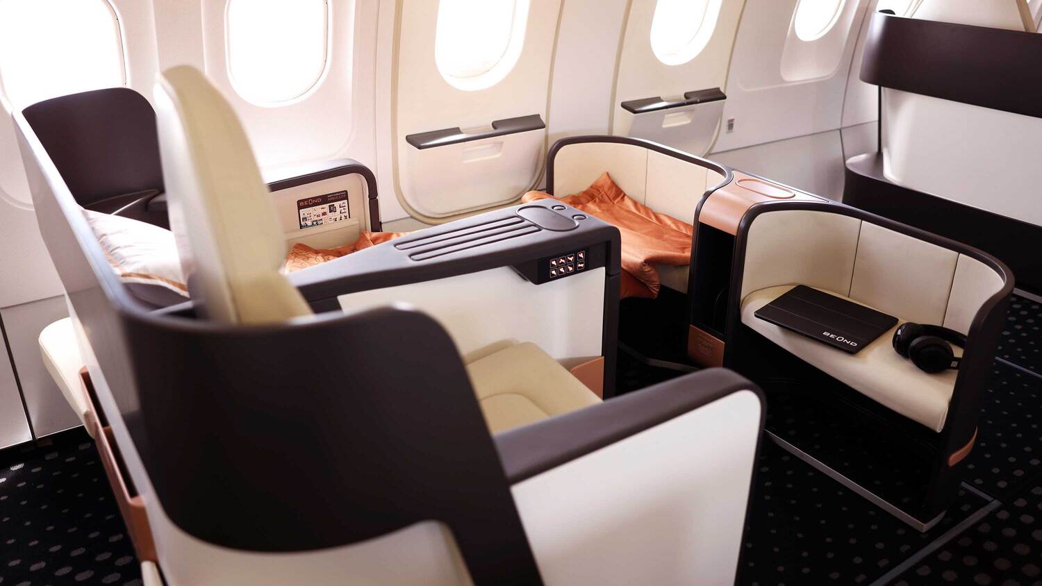 beOnd Airlines business class cabin with a reclined seat and ambient cabin lighting