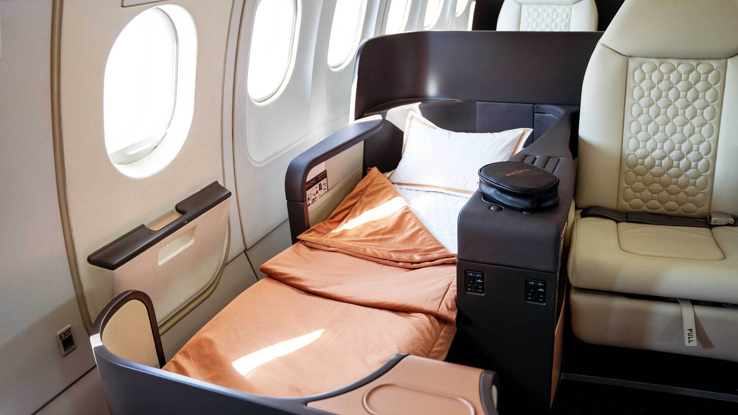 beOnd Airlines seat converted into a lie-flat bed beside the aircraft window