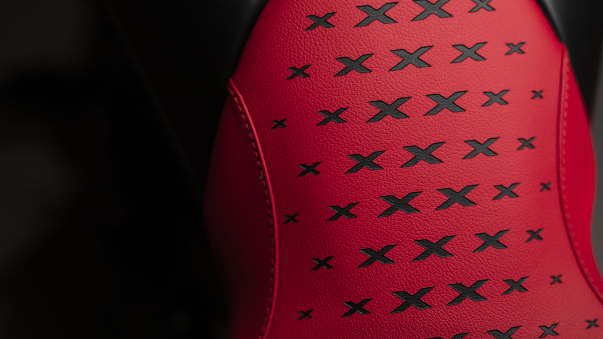Close-up of the Ducati XDiavel seat upholstered in red leather with X-shaped stitching