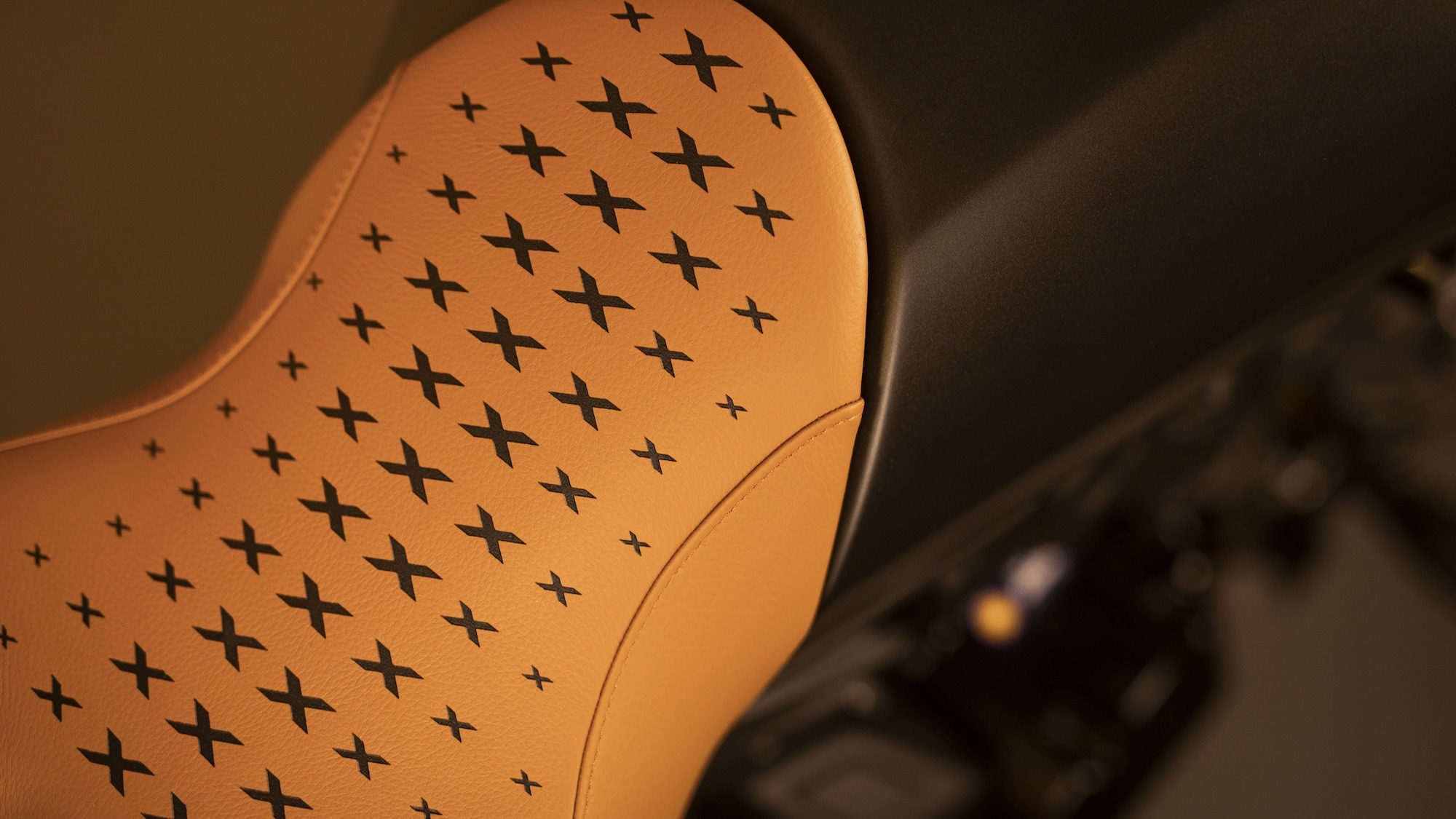 Close-up of the Ducati XDiavel seat in tan leather with a star-pattern stitched design