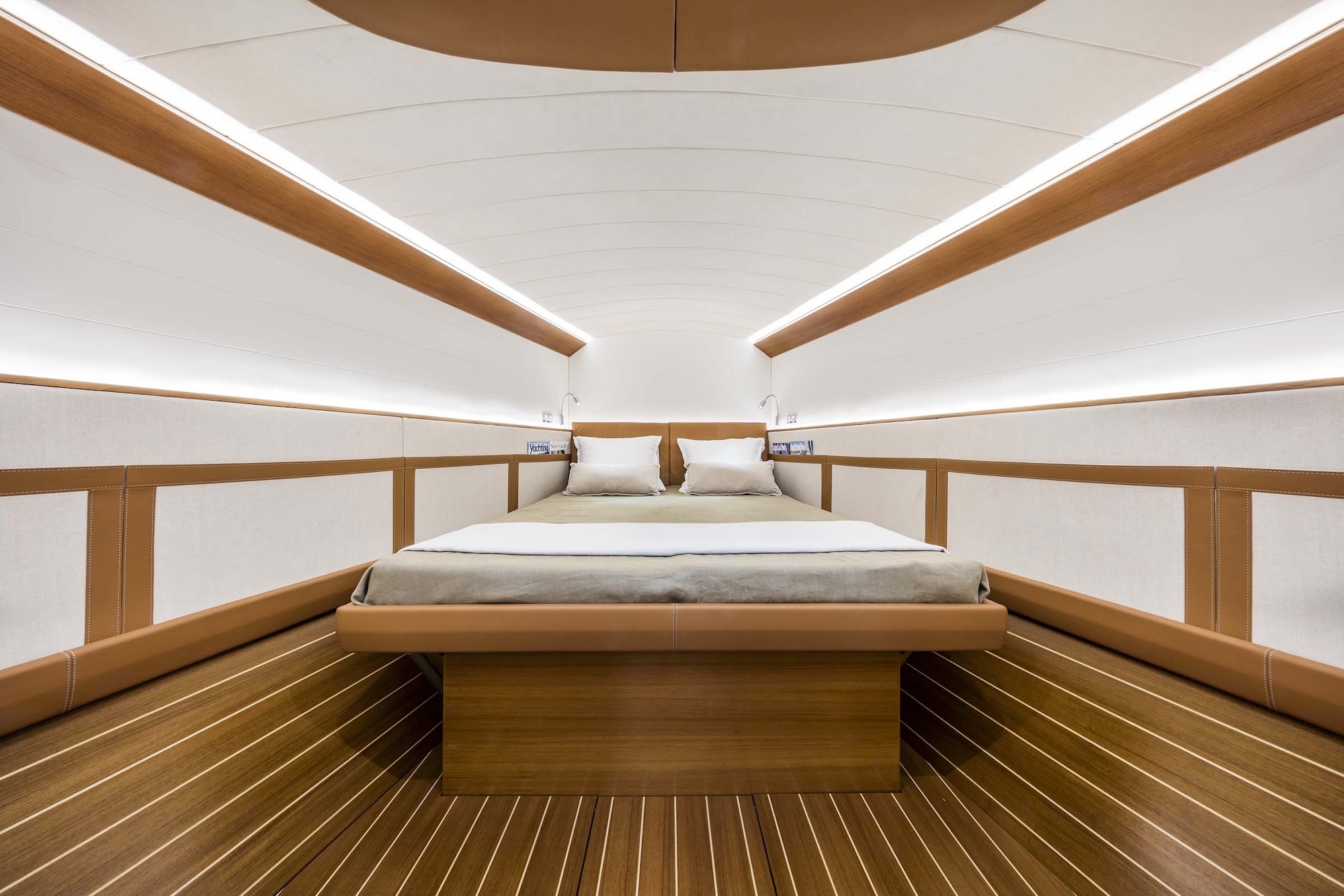 Wood-paneled cabin interior of the ClubSwan 50 sailing yacht with a built-in berth