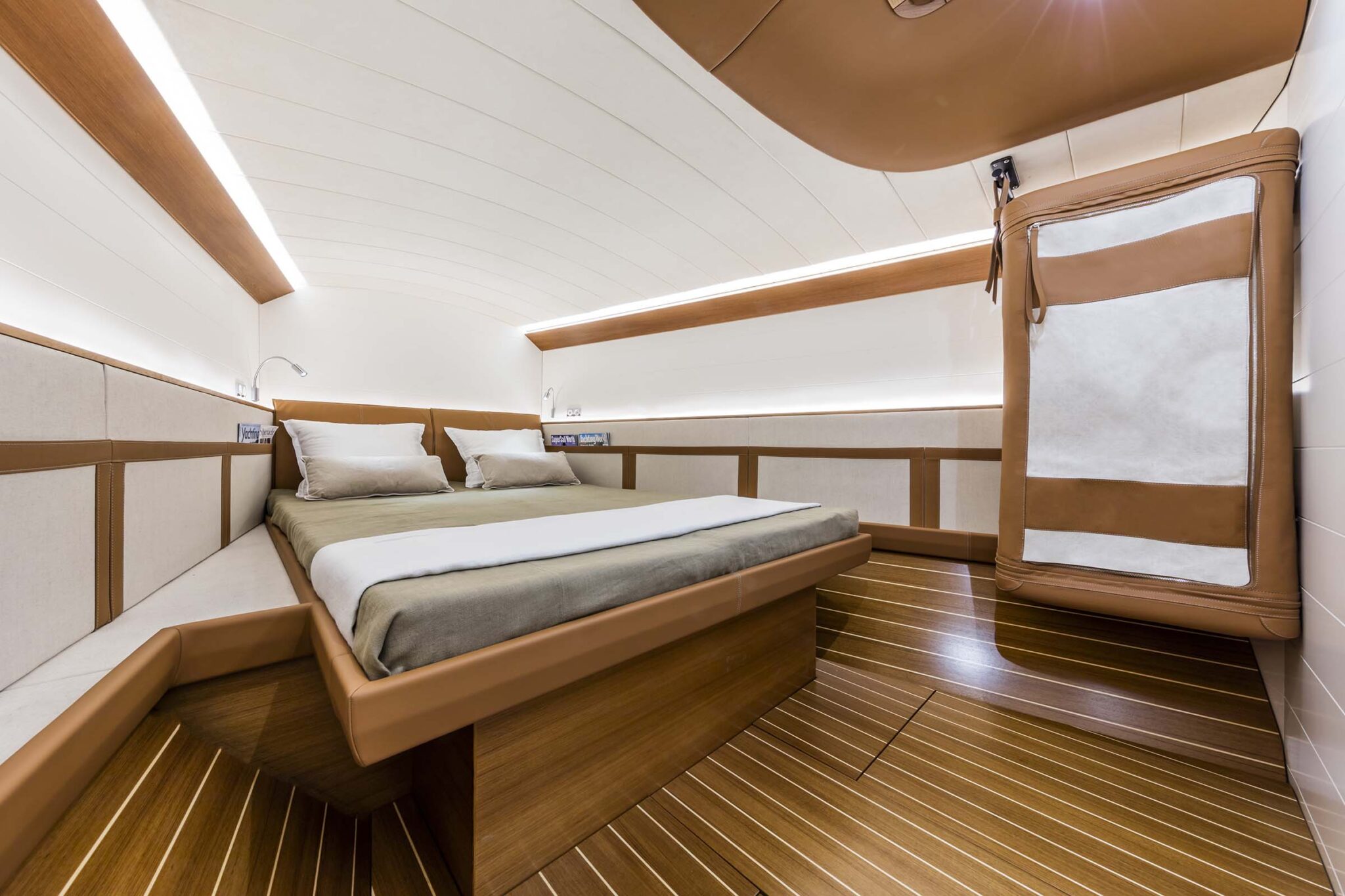 ClubSwan 50 yacht cabin with wood paneling and a built-in bed