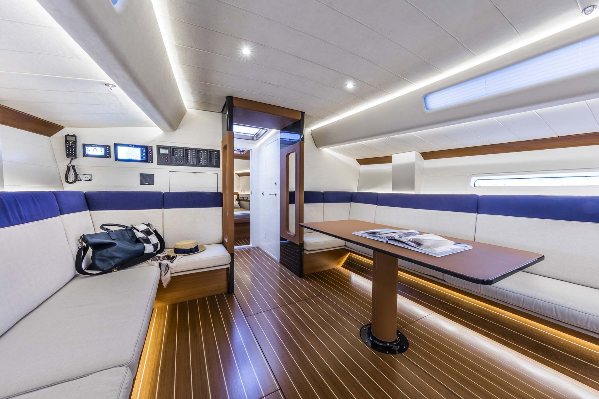 ClubSwan 50 yacht saloon with wood interior and a dining table