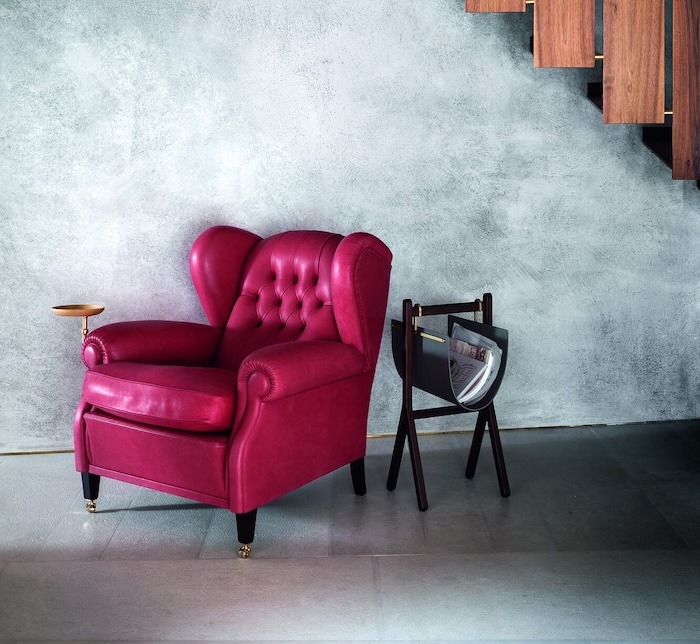 haworth Burgundy leather Poltrona Frau armchair with wooden details in a minimal setting