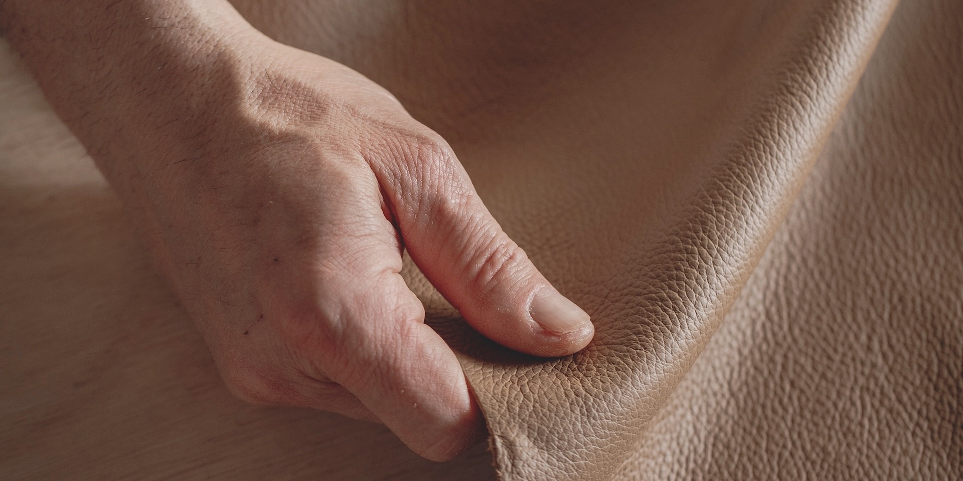Close-up of a hand touching Pelle Frau® leather