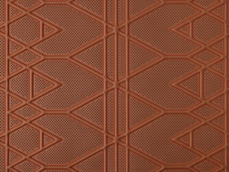 Detail of perforated terracotta leather with geometric triangular stitching