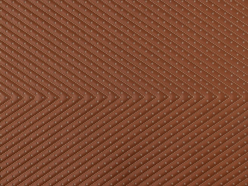 Detail of rust leather with diagonal perforated stripes