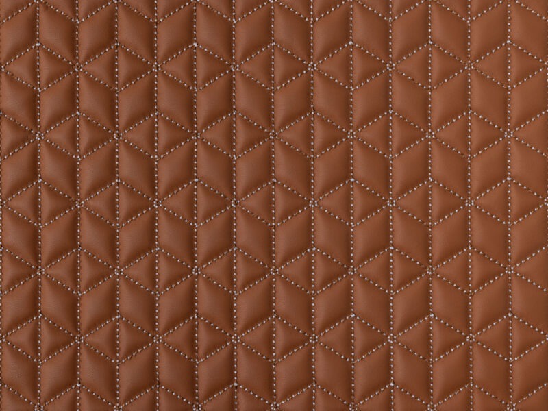 Detail of rust-colored leather with white contrast diamond stitching