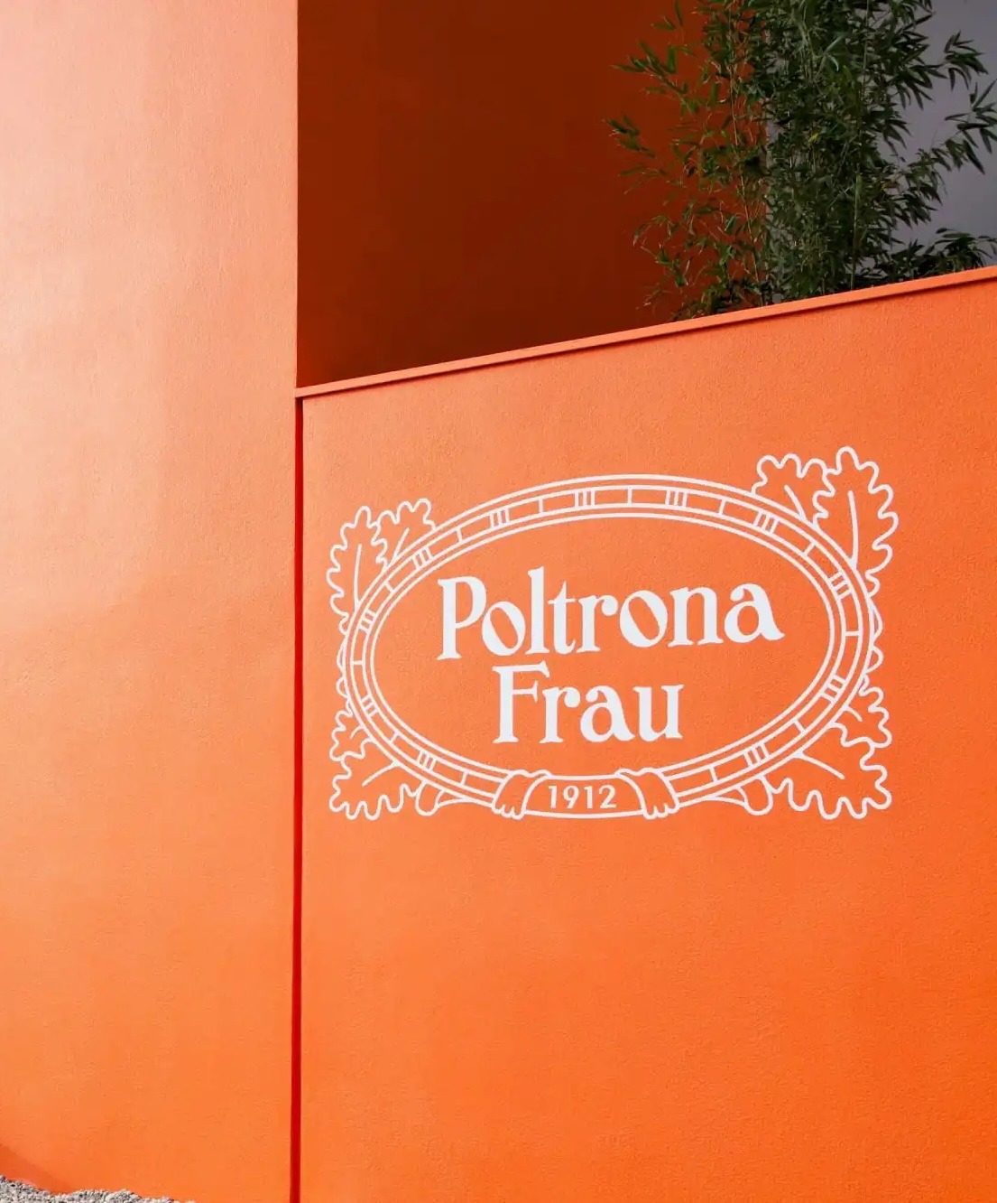 Close-up of the Poltrona Frau brand sign at the entrance of the Poltrona Frau Museum