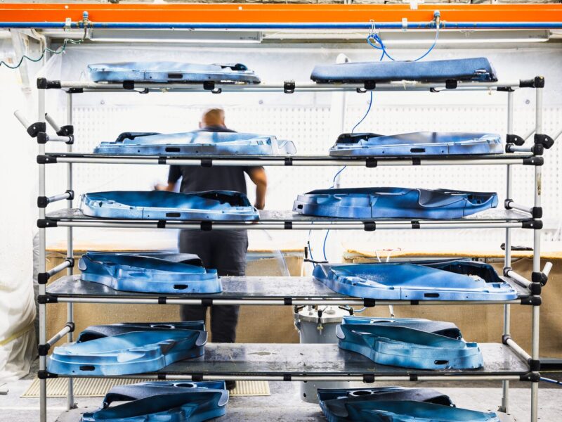 Freshly injection-moulded thermoplastic seat shells in the production area